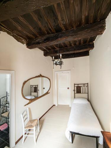 a bedroom with a bed and a mirror at Menhir Rooms in Campobasso