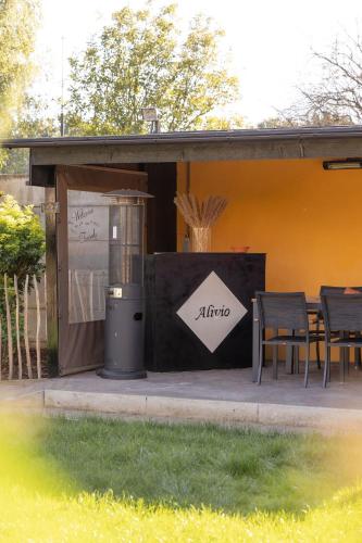 a trash can next to a table and chairs at Alivio - Thuiskomen bij jezelf op vakantie in Lummen