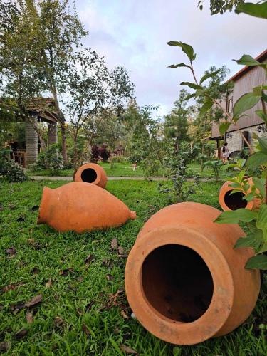 a group of orange pipes sitting in the grass at Iveria Parky and cottages in Shekvetili