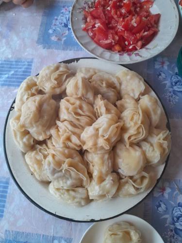 a plate of dumplings on top of a table at Kairat guest house in Kashkaldak