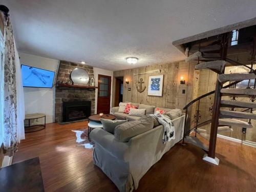a living room with a couch and a fireplace at Racc00ns Retreat in Lake Harmony