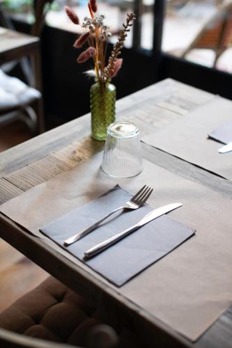 a table with silverware on top of a table at La Maison Clémenceau in Salon-de-Provence