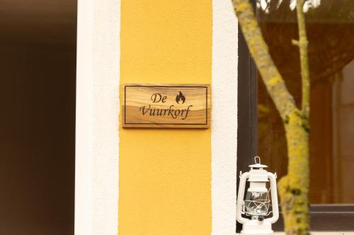 a house with a sign on the side of it at Alivio - Thuiskomen bij jezelf op vakantie in Lummen