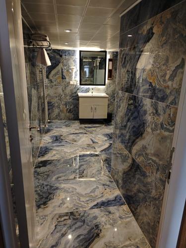 a bathroom with a marble floor and a sink at Hotel Devman in Istanbul