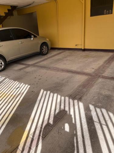 a car parked in a parking lot next to a building at Apartamentos Guzmán in Arenilla