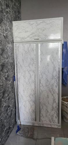 a glass door of a shower in a room at Sweet Candy Studio Apartment in Julianadorp