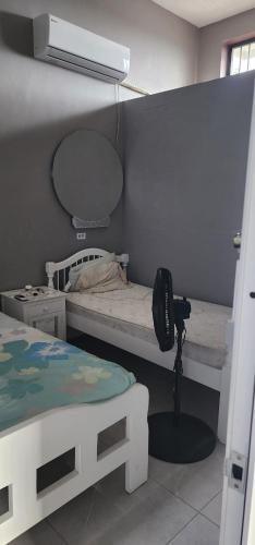 a small room with a bed and a mirror at Sweet Candy Studio Apartment in Julianadorp