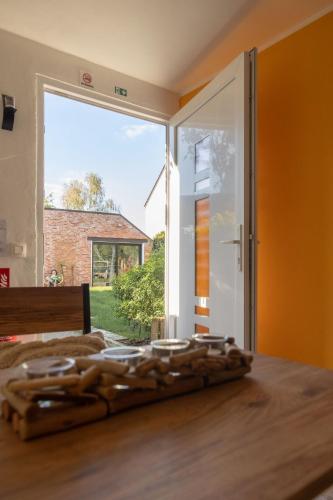 a room with a bed and a large window at Alivio - Thuiskomen bij jezelf op vakantie in Lummen