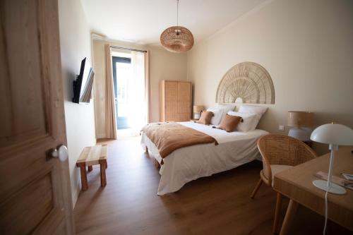 a bedroom with a bed and a desk and a television at La Maison Clémenceau in Salon-de-Provence
