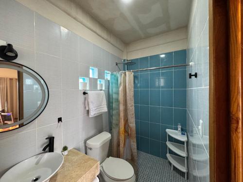 a bathroom with a sink and a toilet and a mirror at Estudio cerca del mar 2 in Puerto Morelos