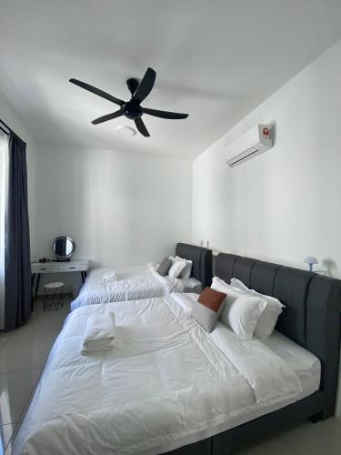 a bedroom with a bed with a ceiling fan at Bukit Indah - Room with Private Bathroom 1-4Pax in Johor Bahru