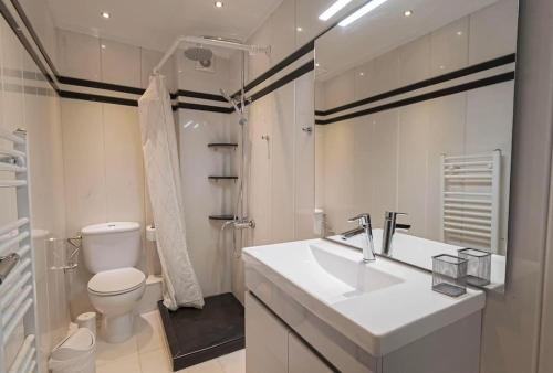 ein weißes Badezimmer mit Waschbecken und Toilette in der Unterkunft Villa Anastazia in Paralia Dionisiou