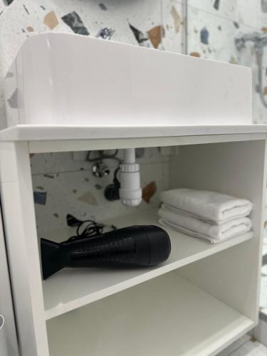 a white bathroom sink on a shelf under a sink at Apartment suite Mukachevo in Mukacheve