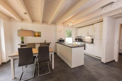 a kitchen and dining room with a table and chairs at Lee - Nordhorn in Nordhorn