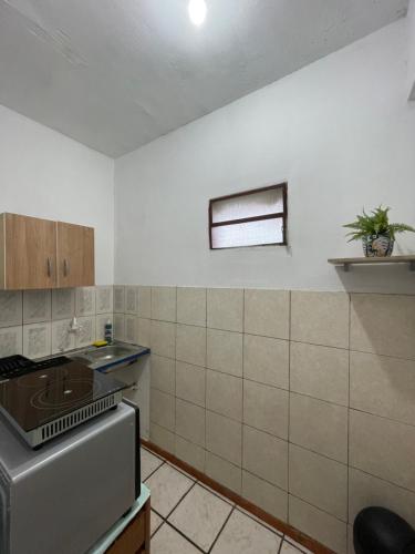 a kitchen with a sink and a stove top oven at Confort total, cerca de todo in Asuncion