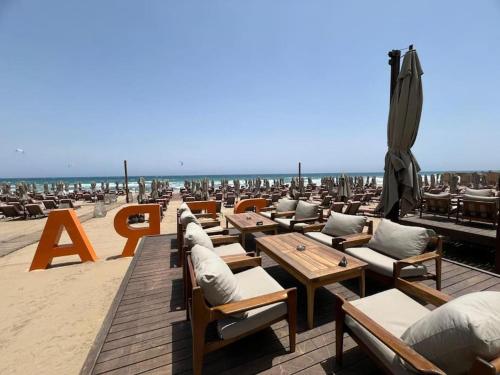 a row of tables and chairs on the beach at Grand Sapphire B10-165 luxury Residence By Myguest Cyprus in Iskele