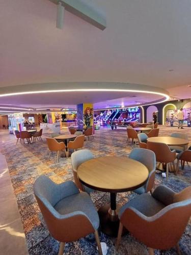 a hotel lobby with tables and chairs and a casino at Grand Sapphire B10-165 luxury Residence By Myguest Cyprus in Iskele