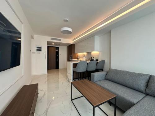 a living room with a couch and a table at Grand Sapphire B10-165 luxury Residence By Myguest Cyprus in Iskele