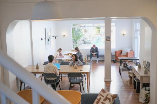 a group of people sitting at tables in a room at Neighbourgood Ravenscraig in Cape Town