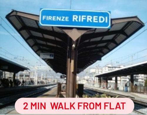 a blue street sign at a train station at Gemme Fiorentine Apartments in front of the train station 5 minutes from the centre Free parking in Florence