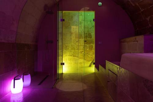 a bathroom with a shower with purple and green lights at Fiorentini 22 - Suite Luxury con SPA in Matera