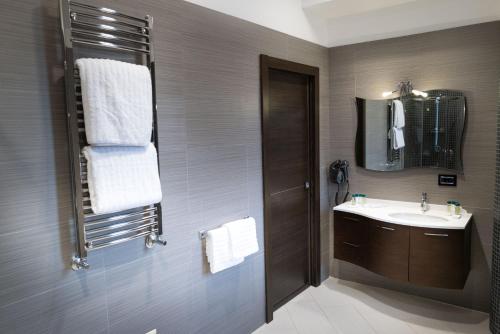 a bathroom with a sink and a mirror at Villa Caribe Resort & Spa in Spigno Saturnia