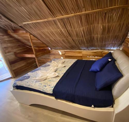 a bed in a room with a ceiling at Casa MAGGY BARU BEACH in Playa Blanca