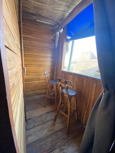 an inside view of a cabin with two chairs and a window at Casa MAGGY BARU BEACH in Playa Blanca