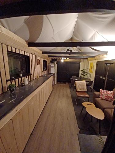 an interior view of a living room and kitchen in an rv at B&B de Kolk in Wilp