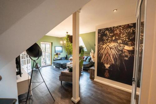 a living room with a large painting on the wall at Landglück - Nordhorn in Nordhorn