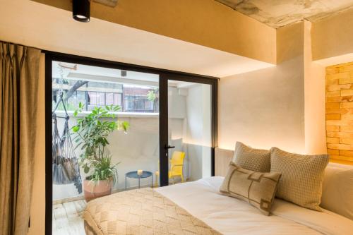 Ένα ή περισσότερα κρεβάτια σε δωμάτιο στο Caliza Roma Residences by Tasman