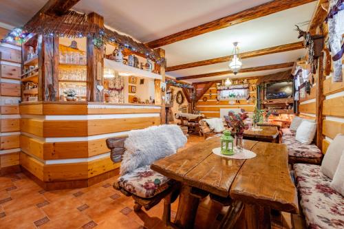 a living room with wooden walls and a wooden table at Apartmány Iwona in Rokytnice nad Jizerou