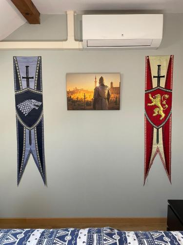a bedroom with three flags on a wall at Appartement balnéo-détente in Sainte-Hélène-du-Lac