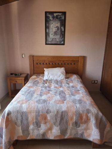 a bedroom with a large bed with a pillow on it at Las casas de las flores in Ibarra