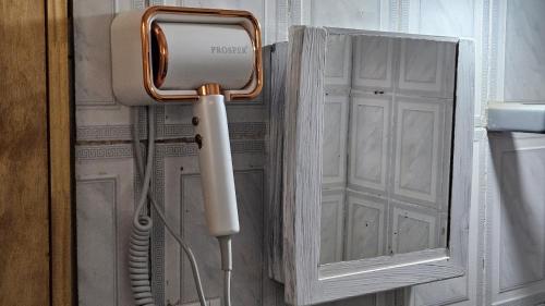 a telephone in a bathroom next to a cabinet at Kurupy in Puerto Iguazú