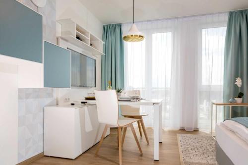 a bedroom with a desk and a bed and a table at NINO-Boardinghouse 23 in Nordhorn