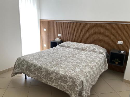 a bedroom with a bed with a blanket on it at La Casa di Annette in Fisciano