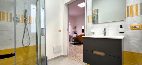 a bathroom with a shower and a sink and a mirror at Casa Sunrise - The Guest House in Sciacca