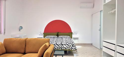 a living room with a couch and a bed at Casa Sunrise - The Guest House in Sciacca