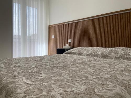 a bedroom with a large bed with a large blanket at La Casa di Annette in Fisciano