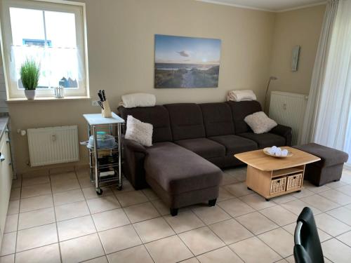 a living room with a couch and a table at Ferienwohnung Meeresleuchten - Glowe in Glowe