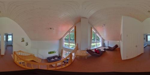 a living room with a large archway in a house at Ferienhaus Haus am See - Nordhorn in Nordhorn