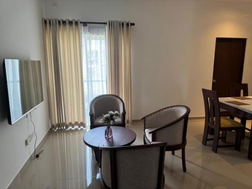 a living room with a table and chairs and a dining room at Family Friendly 3BR Apartment in Malabe, Colombo in Talahena