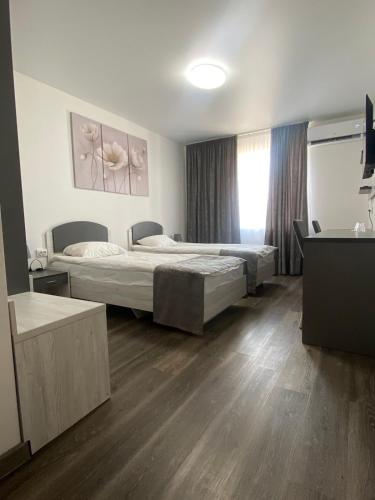 a hotel room with two beds and a window at Артур in Berdychiv