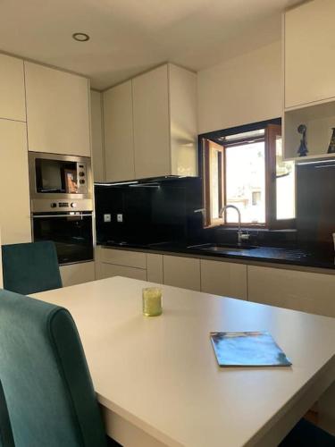 a kitchen with a table with a book on it at Casa do Cruzeiro in Santo Adrião