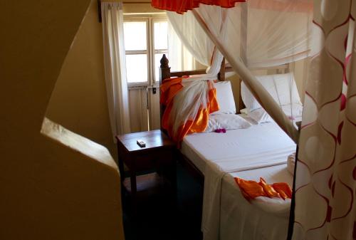 a bedroom with two beds and a window at Princess Salme Inn in Zanzibar City