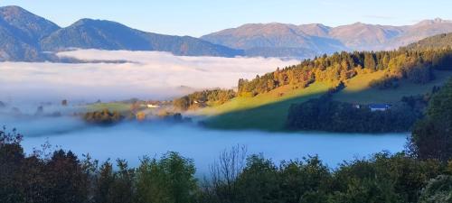 a view of a lake in the mountains with clouds at Apartments Krista in Seeboden
