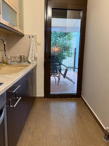 a kitchen with a door leading to a patio at Fani's Home No 14 in Tríkala