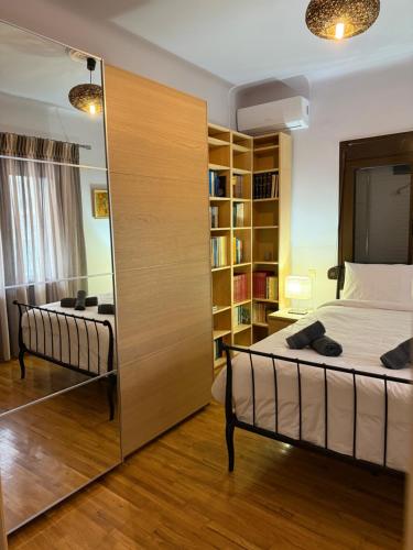 a bedroom with a bed and a book shelf at Fani's Home No 14 in Tríkala
