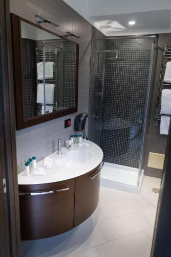 a bathroom with a sink and a shower at Villa Caribe Resort & Spa in Spigno Saturnia